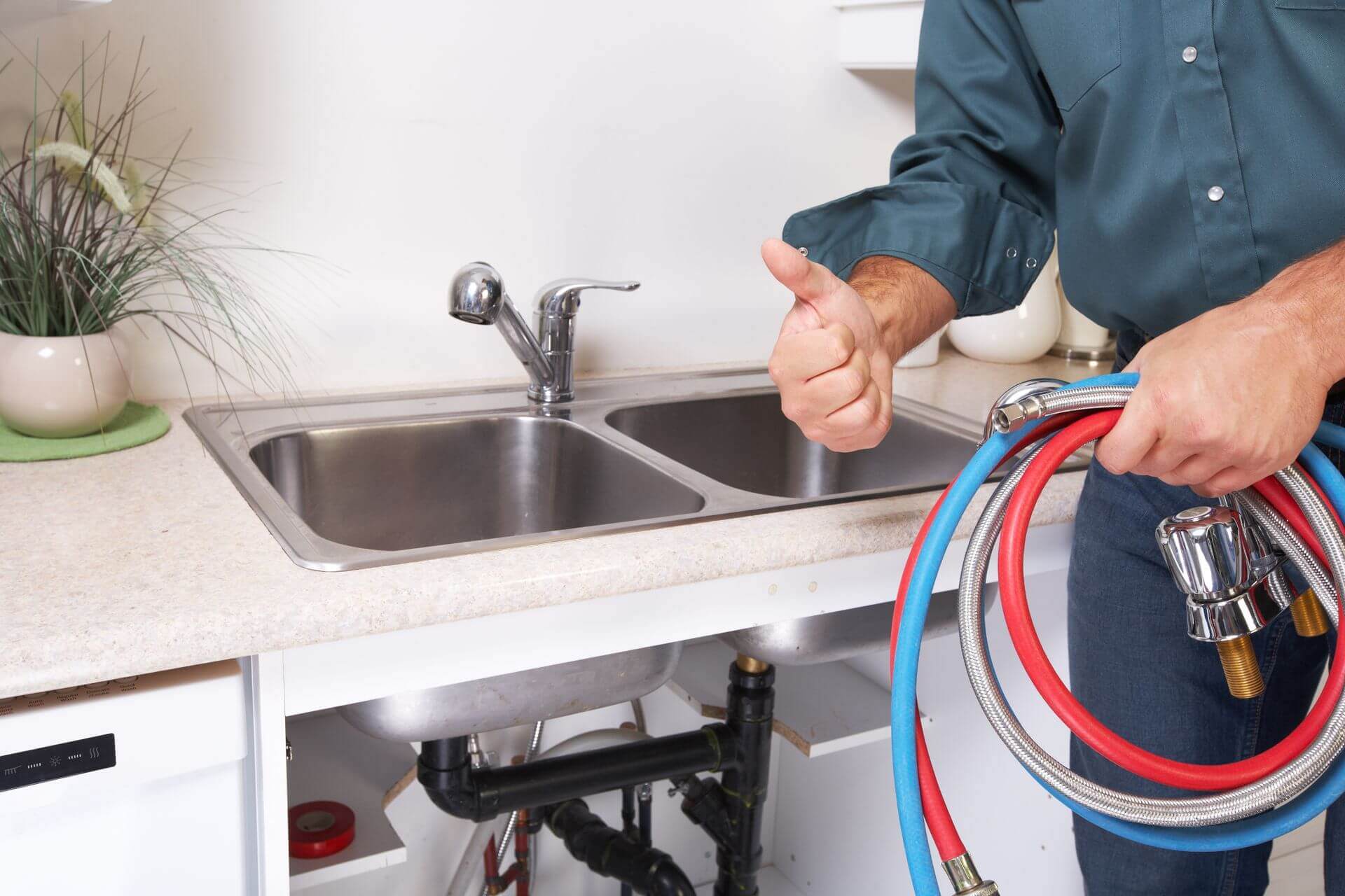 man giving thumbs up while holding pipe on other hand