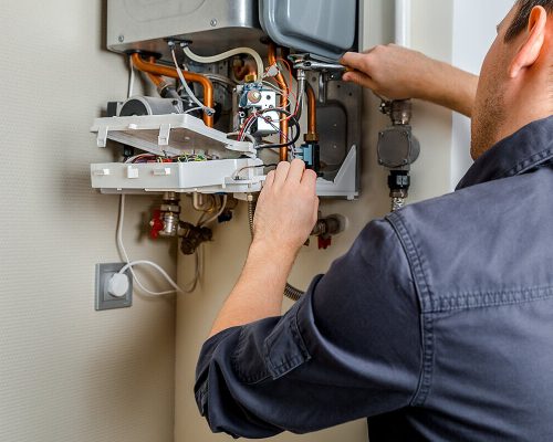 man repairing the boiler