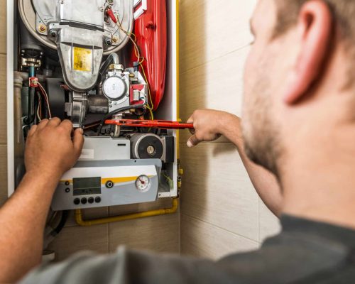 man repairing the boiler