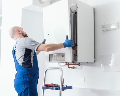 man installing the boiler