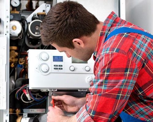 man repairing the boiler