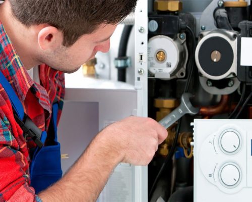 man repairing the boiler