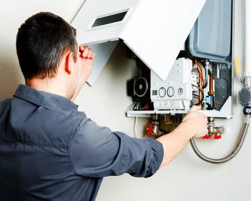 man repairing the boiler