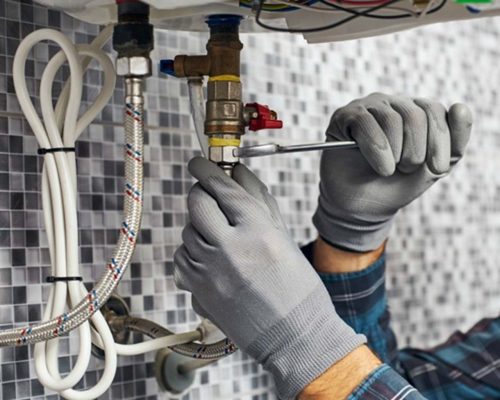 man repairing the boiler