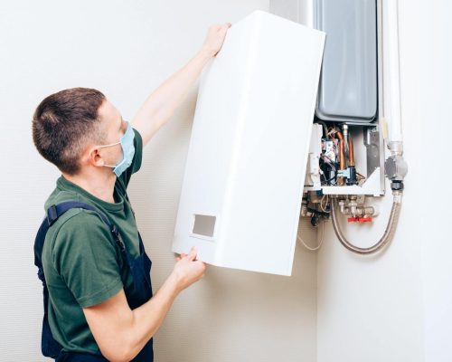 man fitting the boiler